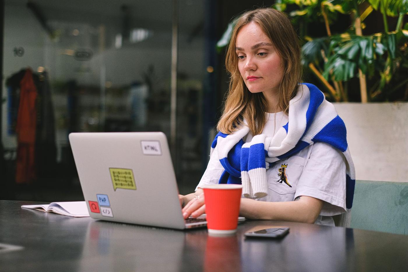 Woman working on a laptop in a cafe
